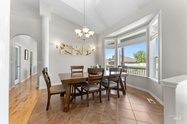 4019 E Man O War Dr, Nampa, ID 83686 - dining area with arched walkways, lofted ceiling, a chandelier, and light tile patterned floors