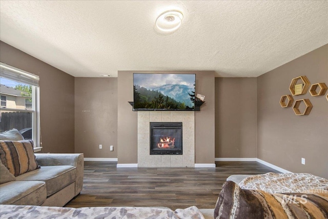 9308 W Rustica Dr, Boise, ID 83709 - living room featuring wood finished floors, a tile fireplace, and a textured ceiling