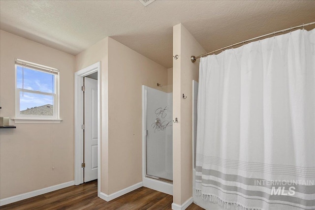 9308 W Rustica Dr, Boise, ID 83709 - full bathroom with wood finished floors, a shower with curtain, and a textured ceiling