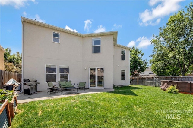9308 W Rustica Dr, Boise, ID 83709 - rear view of house featuring a fenced backyard, a patio, and stucco siding