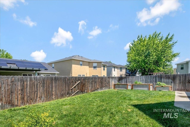 9308 W Rustica Dr, Boise, ID 83709 - fenced backyard featuring a vegetable garden and a residential view