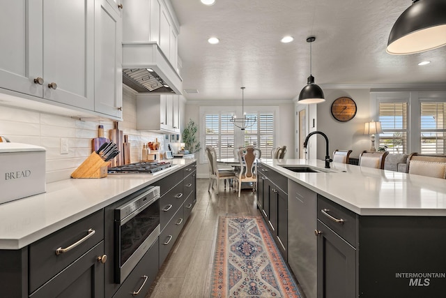 2245 N Burnam Ave, Star, ID 83669 - kitchen with ornamental molding, recessed lighting, light countertops, a sink, and appliances with stainless steel finishes