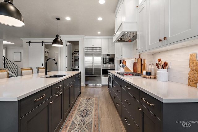2245 N Burnam Ave, Star, ID 83669 - kitchen with recessed lighting, light countertops, white cabinetry, a sink, and stainless steel appliances