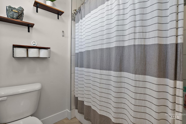 2245 N Burnam Ave, Star, ID 83669 - bathroom with baseboards, a shower with curtain, and toilet
