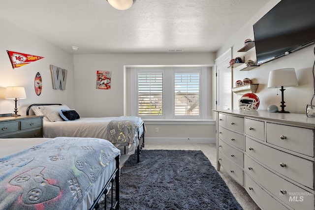 2245 N Burnam Ave, Star, ID 83669 - bedroom featuring a textured ceiling, baseboards, visible vents, and light carpet