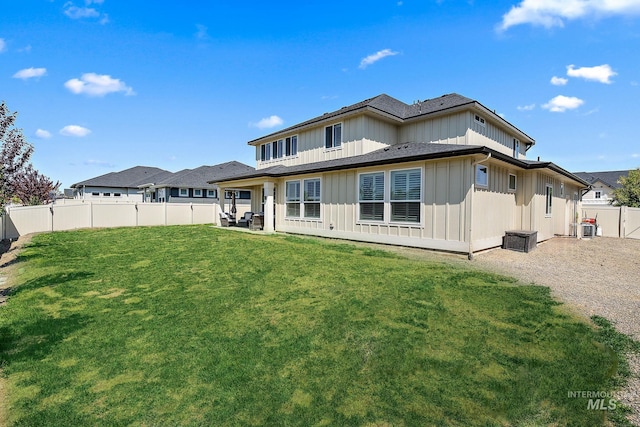 2245 N Burnam Ave, Star, ID 83669 - back of house featuring board and batten siding, a yard, and a fenced backyard