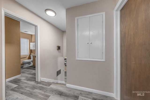 interior space with visible vents, light wood finished floors, and baseboards