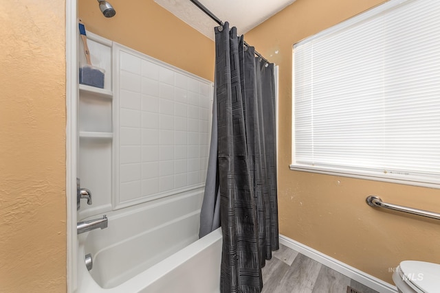 full bathroom with toilet, baseboards, shower / tub combo with curtain, and wood finished floors