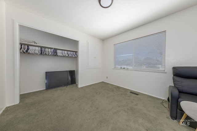 carpeted home office featuring visible vents and baseboards