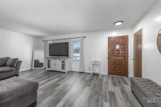 living room featuring wood finished floors and baseboards