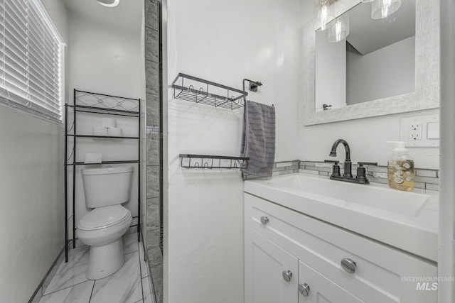 full bathroom featuring marble finish floor, vanity, and toilet