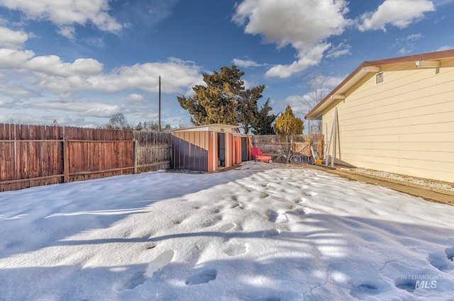 view of yard featuring a storage unit and a fenced backyard