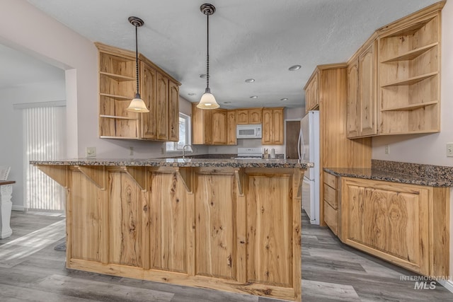 kitchen with open shelves, white appliances, a peninsula, light wood-style floors, and pendant lighting