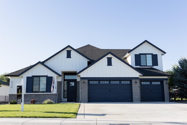 modern farmhouse style home with driveway, a front lawn, board and batten siding, and roof with shingles