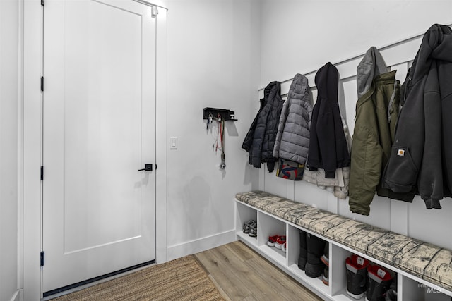 mudroom featuring light wood finished floors and baseboards