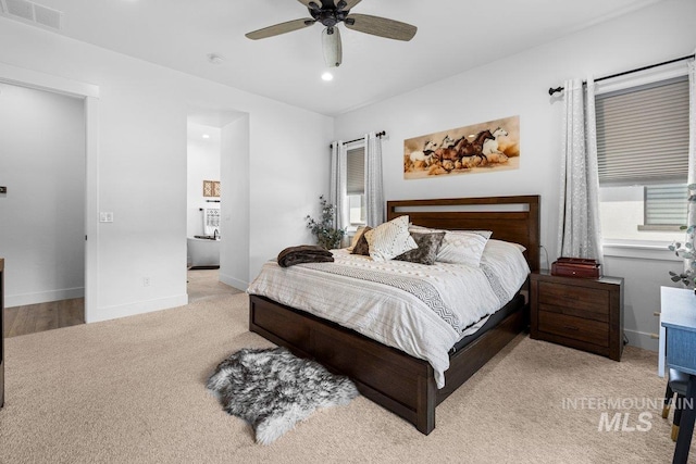 bedroom featuring light colored carpet, recessed lighting, baseboards, and ceiling fan