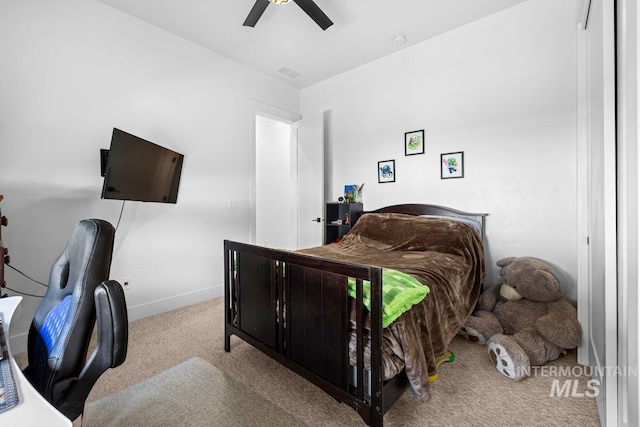 bedroom featuring carpet floors, a desk, a ceiling fan, and baseboards