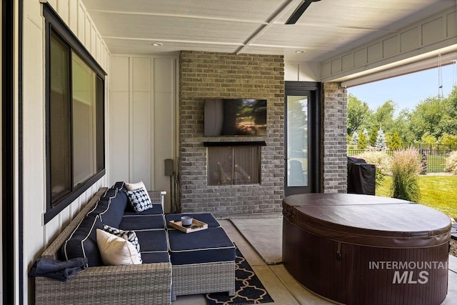 view of patio featuring a hot tub and an outdoor living space