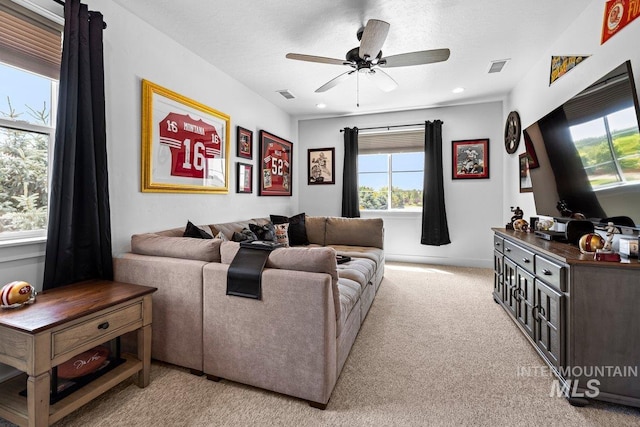 living room featuring a ceiling fan, light colored carpet, and recessed lighting