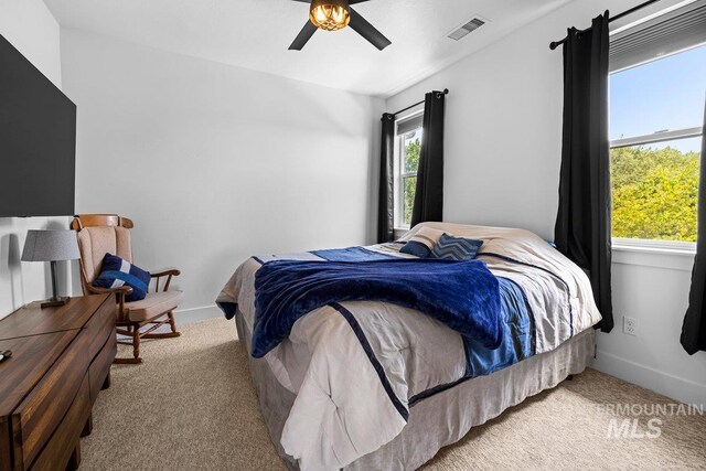 bedroom with carpet floors, ceiling fan, and baseboards
