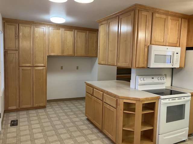 kitchen with brown cabinets, white appliances, light countertops, baseboards, and light floors