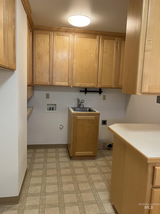 laundry area featuring baseboards, hookup for a washing machine, cabinet space, electric dryer hookup, and a sink