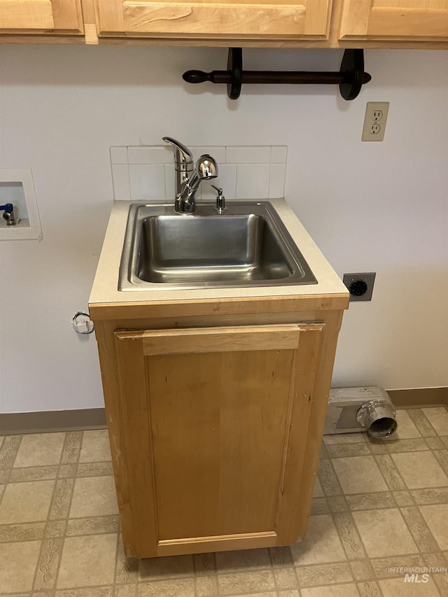 interior details with baseboards and a sink