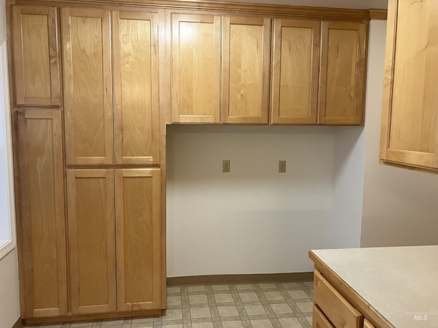 kitchen featuring light countertops, light floors, and baseboards