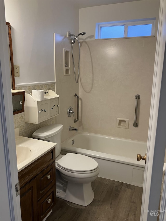 full bath with bathtub / shower combination, vanity, toilet, and wood finished floors