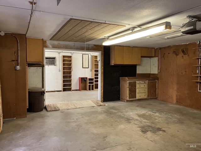 garage featuring a garage door opener and a wall mounted air conditioner