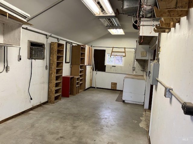 below grade area with a garage and an AC wall unit