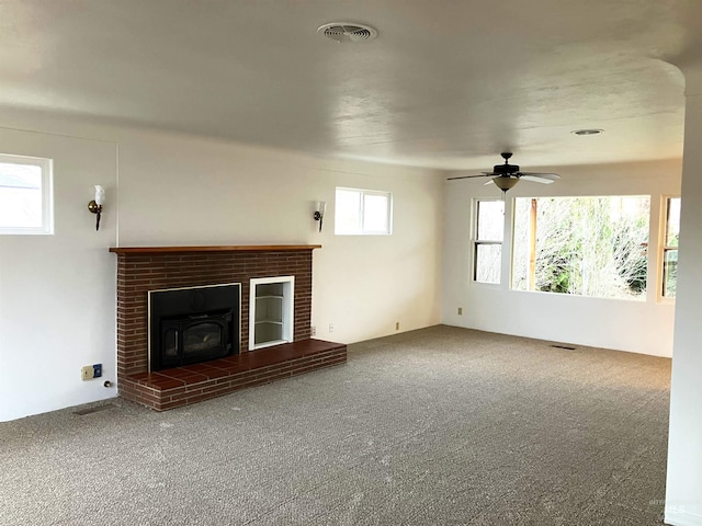 unfurnished living room featuring visible vents, carpet floors, and a ceiling fan