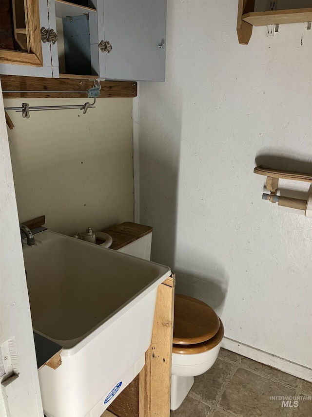 bathroom featuring toilet and a sink