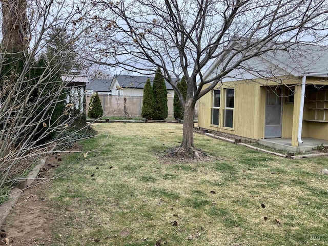 view of yard featuring a patio and fence