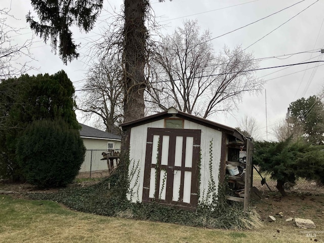 view of shed featuring fence