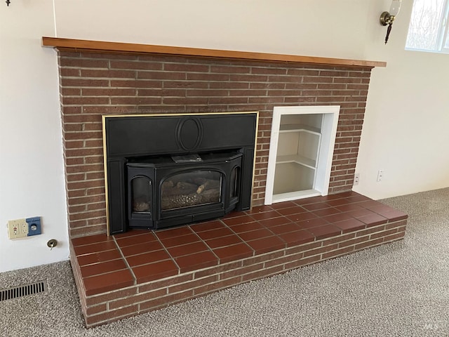 interior details with visible vents, a brick fireplace, and carpet floors