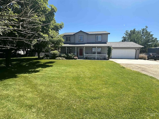 view of front facade featuring a garage, a front yard, a porch, and driveway