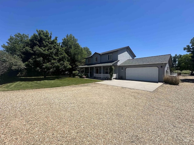 view of front of property featuring a front lawn, a porch, concrete driveway, and an attached garage