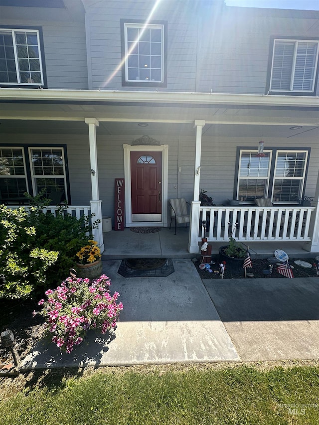 property entrance with covered porch