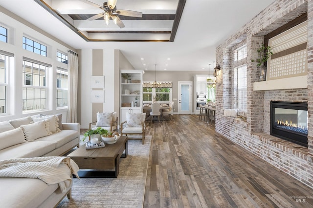 1747 N Tuscolano Ave, Eagle, ID 83616 - living area with hardwood / wood-style flooring, a ceiling fan, a fireplace, a towering ceiling, and recessed lighting