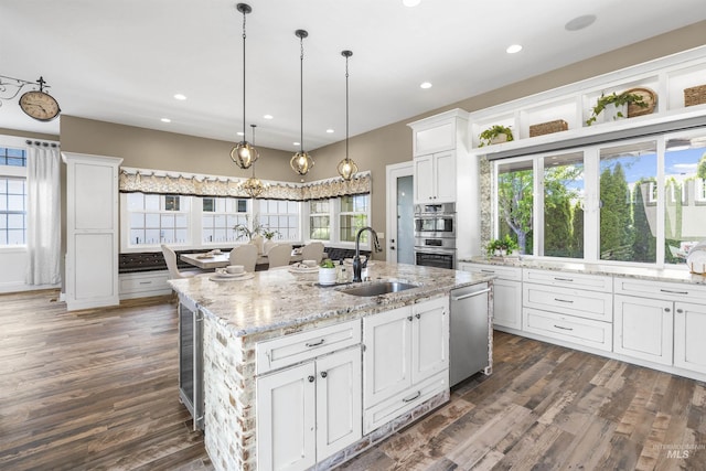1747 N Tuscolano Ave, Eagle, ID 83616 - kitchen featuring appliances with stainless steel finishes, white cabinets, a center island with sink, dark wood-style flooring, and recessed lighting