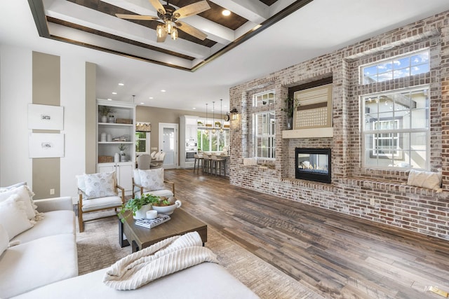 1747 N Tuscolano Ave, Eagle, ID 83616 - living area with wood finished floors, brick wall, a fireplace, a ceiling fan, and recessed lighting