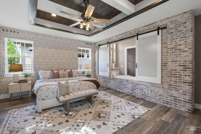 1747 N Tuscolano Ave, Eagle, ID 83616 - bedroom featuring a barn door, wood finished floors, a raised ceiling, and wallpapered walls