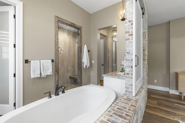 1747 N Tuscolano Ave, Eagle, ID 83616 - full bath featuring a tub to relax in, a stall shower, wood finished floors, vanity, and a chandelier