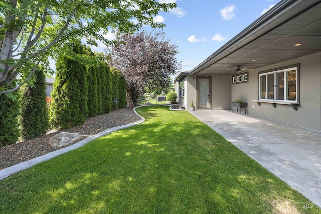 1747 N Tuscolano Ave, Eagle, ID 83616 - view of green lawn with ceiling fan, a patio area, and a carport