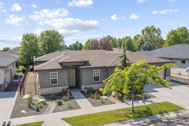 1747 N Tuscolano Ave, Eagle, ID 83616 - prairie-style home featuring concrete driveway, a gate, stucco siding, a garage, and roof with shingles