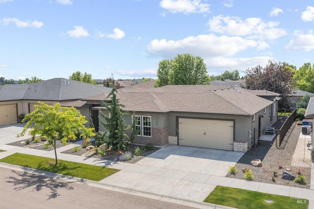 1747 N Tuscolano Ave, Eagle, ID 83616 - ranch-style house featuring an attached garage, concrete driveway, a gate, roof with shingles, and stucco siding