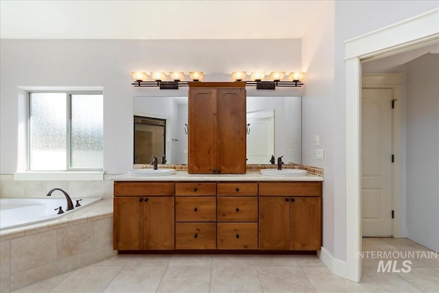 bathroom with tile patterned flooring, double vanity, a garden tub, and a sink