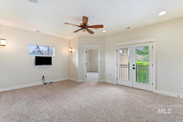 unfurnished living room featuring a wealth of natural light, french doors, visible vents, and carpet floors