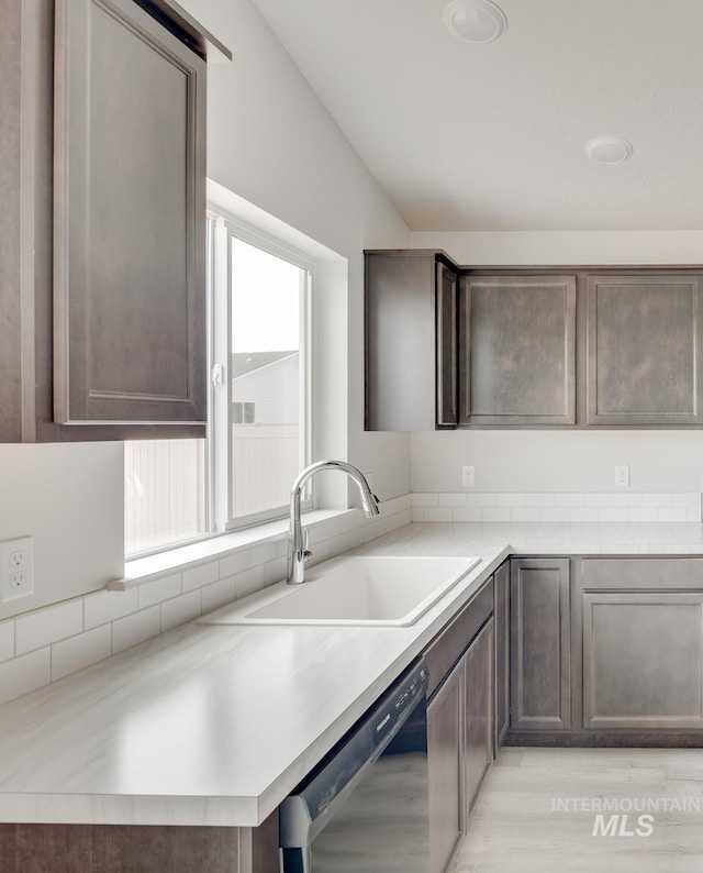 kitchen with sink, dark brown cabinets, and dishwasher